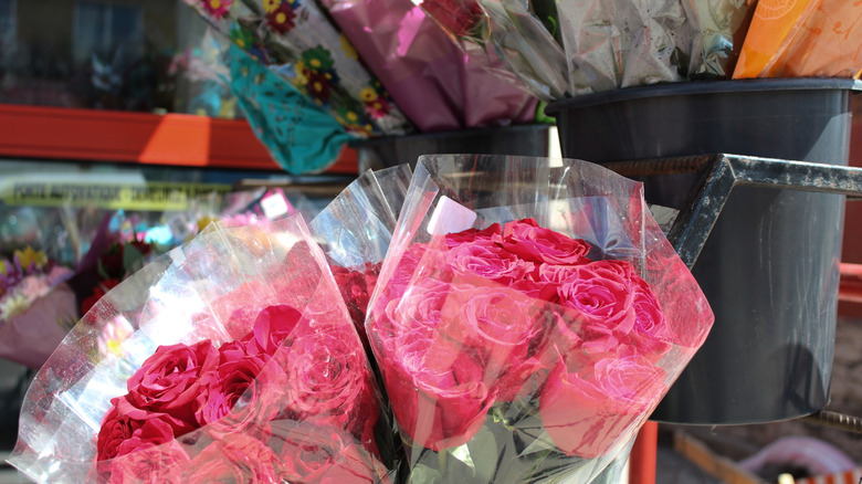 Pink roses and other flowers wrapped in plastic