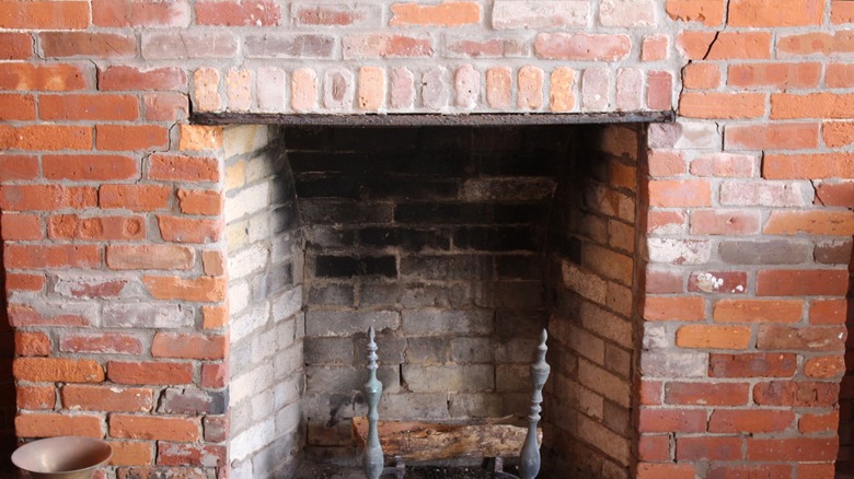 An old brick fireplace with cracks