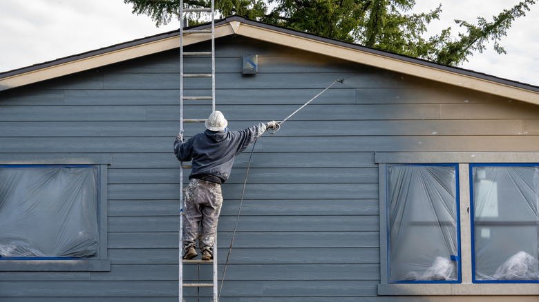 professional painter working on exterior of home