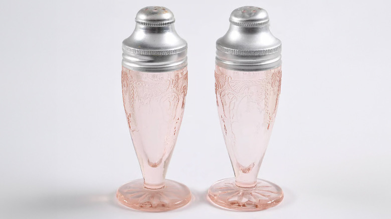 A set of Hocking Cameo Pink Salt and Pepper Shakers is shown in a detail shot