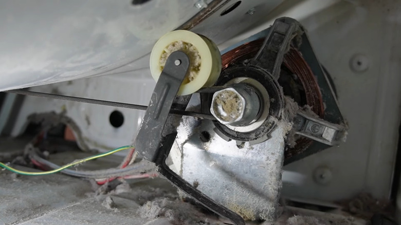 Closeup of an idler pulley inside of a dryer