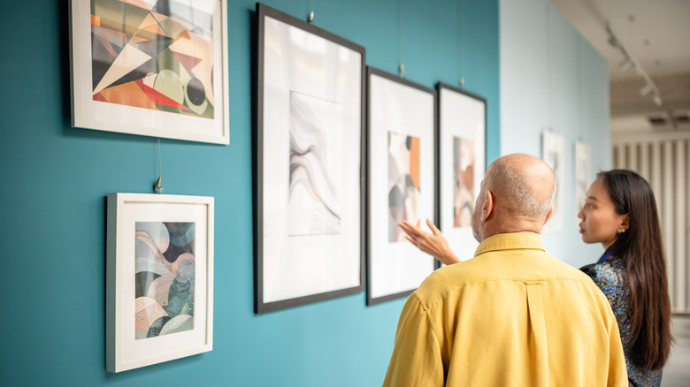 Two people discussing a gallery wall