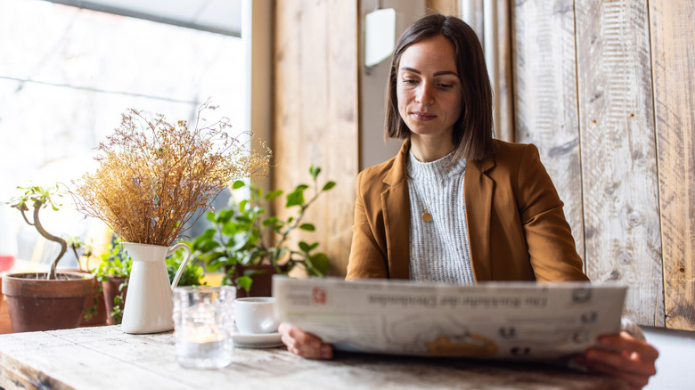 woman reading newspaper
