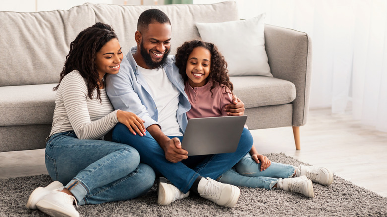 family by living room couch