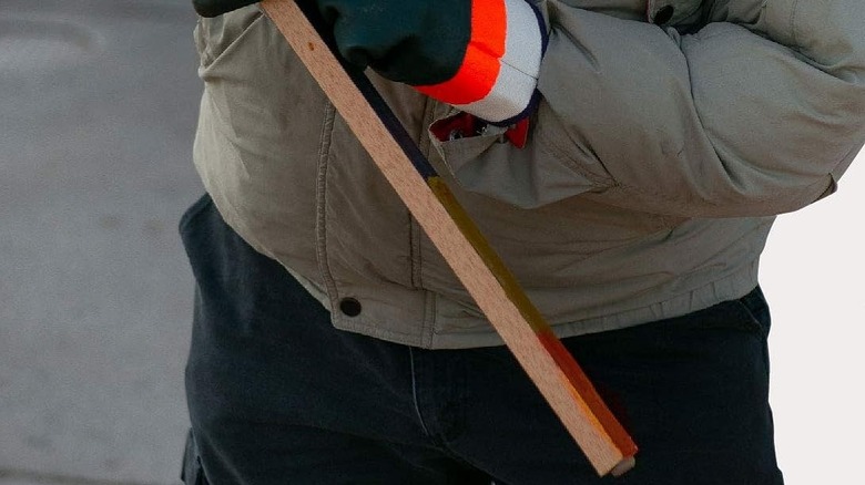 Checking a dipstick with water detection paste on it