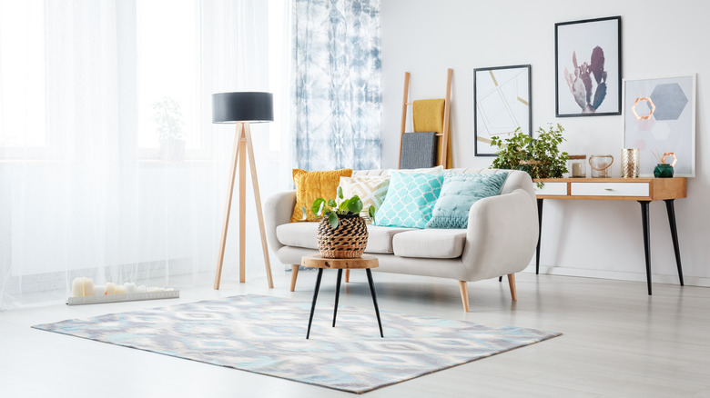 narrow table behind white sofa