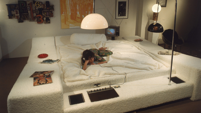 Woman laying on a white oversized waterbed