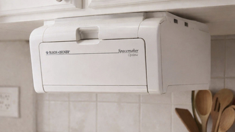 Product image of Black & Decker Spacemaker installed underneath a kitchen cabinet, utensils and backsplash in the background.