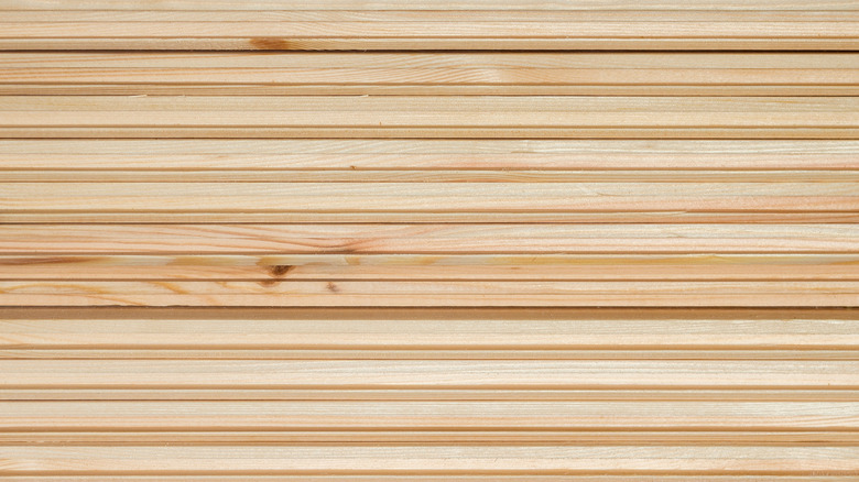 A close-up of unfinished beaded plywood.