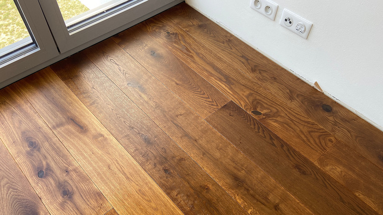 Engineered Oak flooring just installed by glass doors.