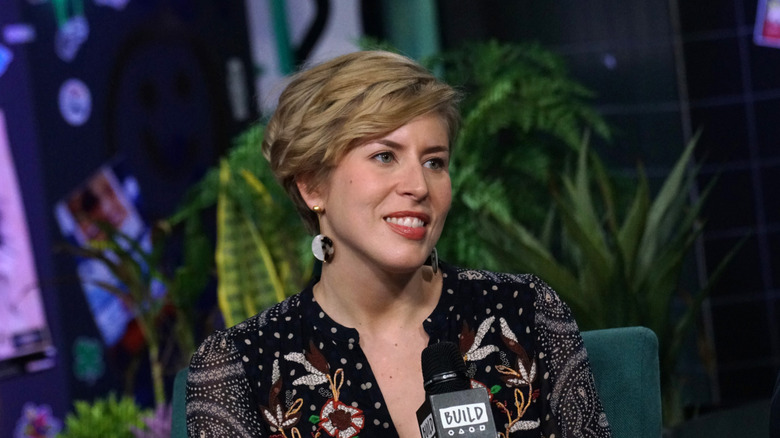 Erin Napier holding a mic during a TV interview.