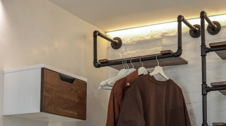 A hanging shelf with a clothing rod