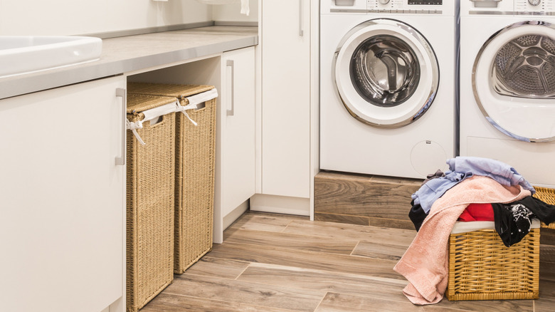 Laundry hampers tucked away in a laundry room