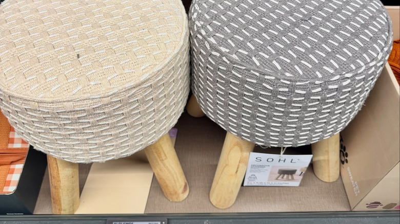 A beige and a grey ottoman on display at an Aldi store.