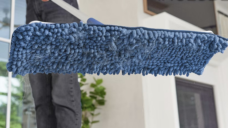 Person holding up Bona Floor Mop Starter Kit with microfiber sweeping pad