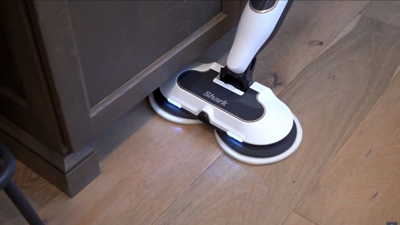 Man using Shark Steam & Scrub in bedroom with dogs