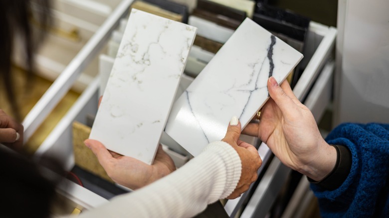 two people holding countertop samples