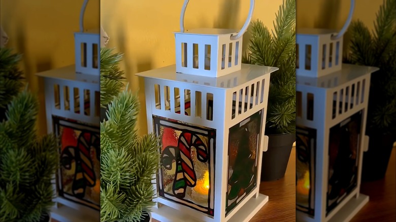 small white lantern with Christmas themed faux stained glass