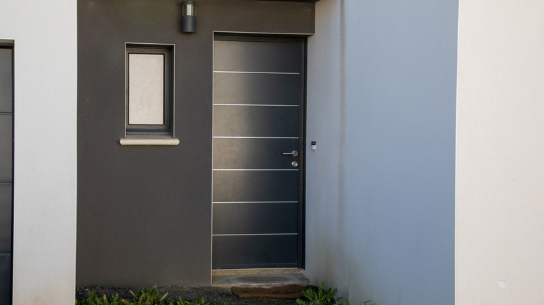 steel gray front door of modern home