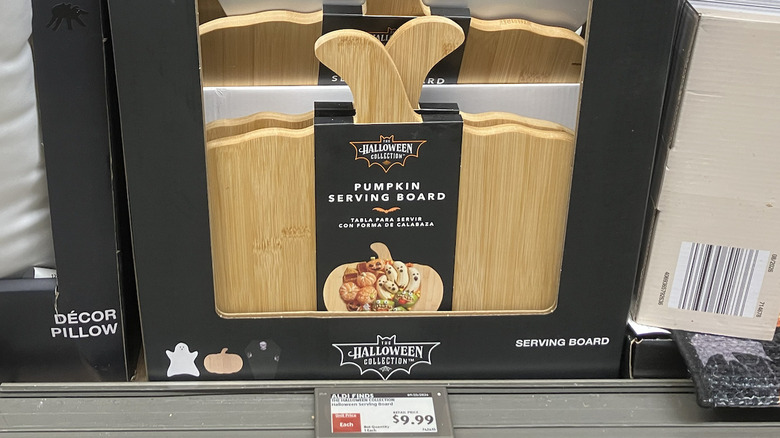 Wooden pumpkin-shaped serving board for sale at Aldi.