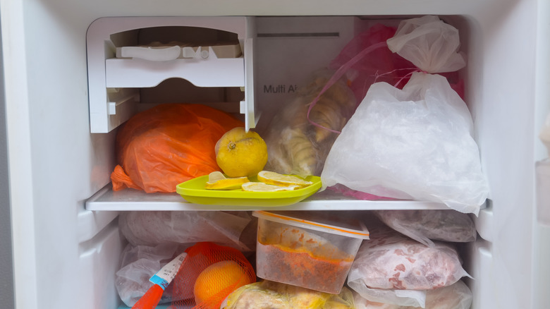 Inside of a freezer stocked with various items including fruit and leftovers