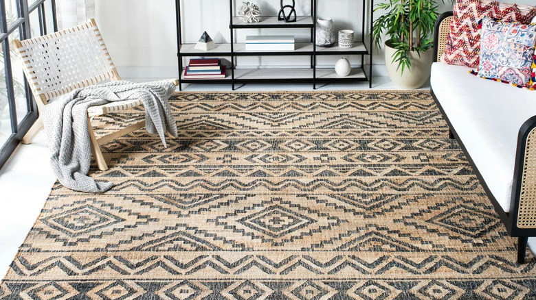 A living room with a geometric-patterned area rug