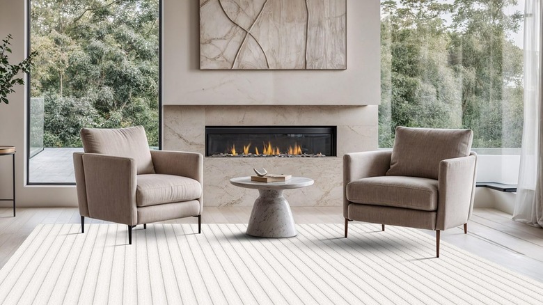 A living room with a large, ribbed area rug