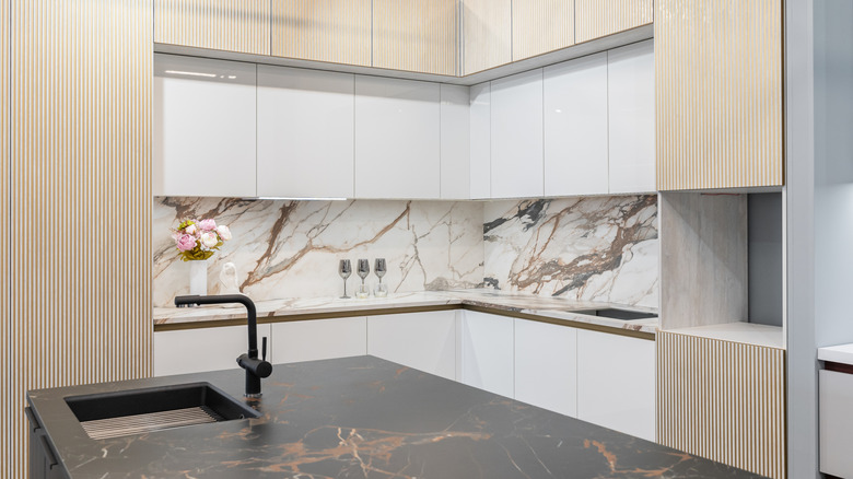 marble slab backsplash in modern kitchen with brown veining