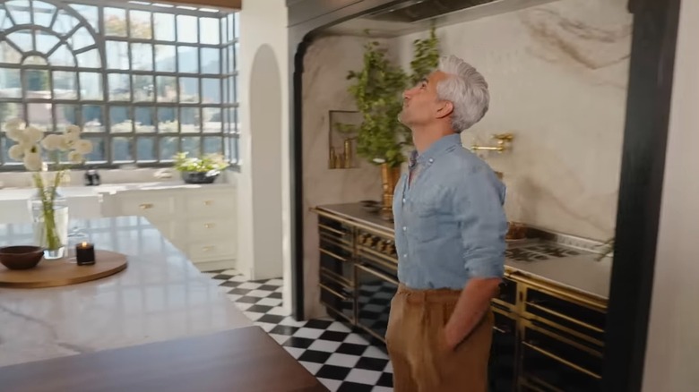 Tan France in his kitchen featuring L'Atelier stove and marble alcove