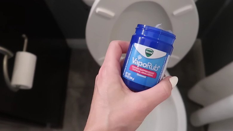 VapoRub held over a toilet