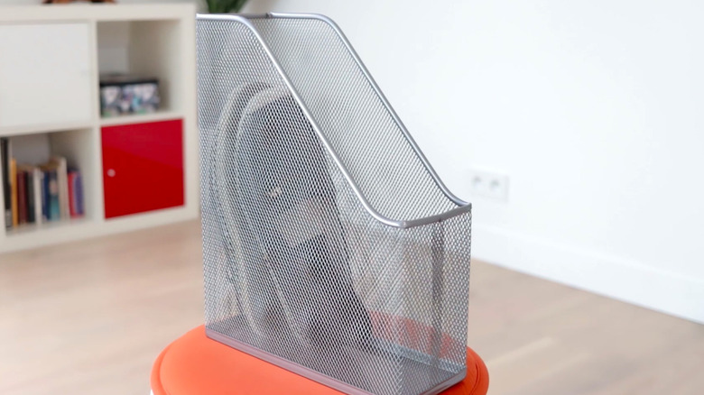 Close up of metal magazine holder with shoes inside