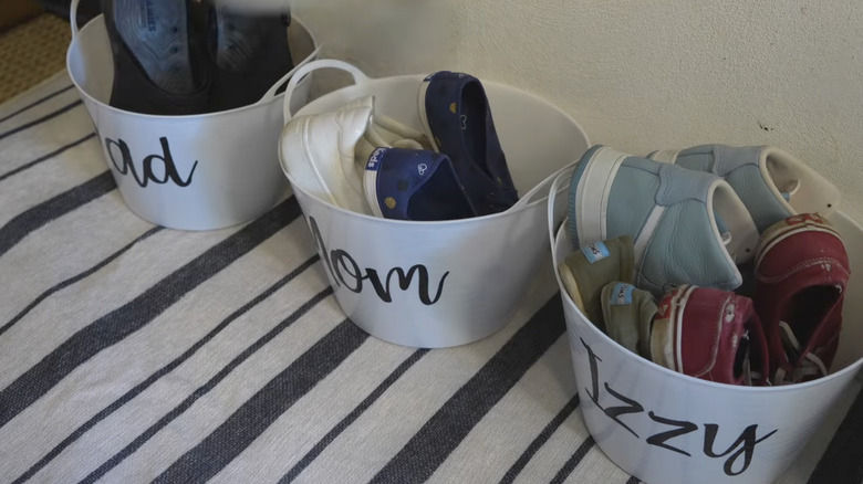 Shoes organized in plastic buckets