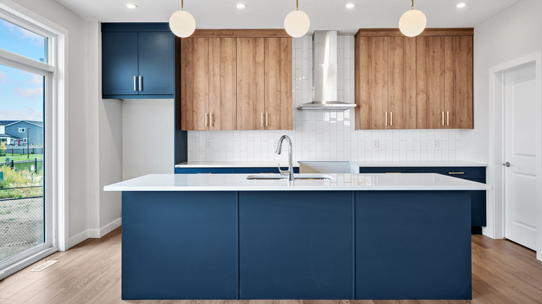 Kitchen with blue and honey oak cabinets