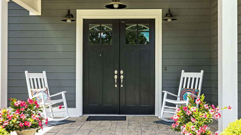 Matte black French doors leading to a flagstone porch