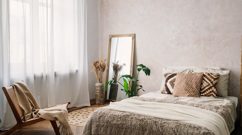 A rainbow circle of different paint colour swatches with a paintbrush in the middle.