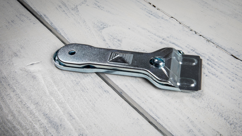 Metal scraper used on ceramic or glass surfaces