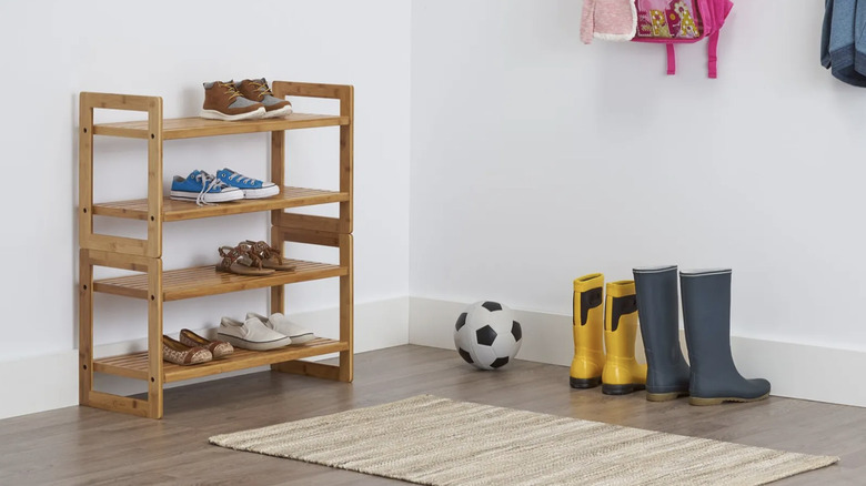 Costco bamboo shoe racks stacked on top of each other with pairs of shoes on each shelf