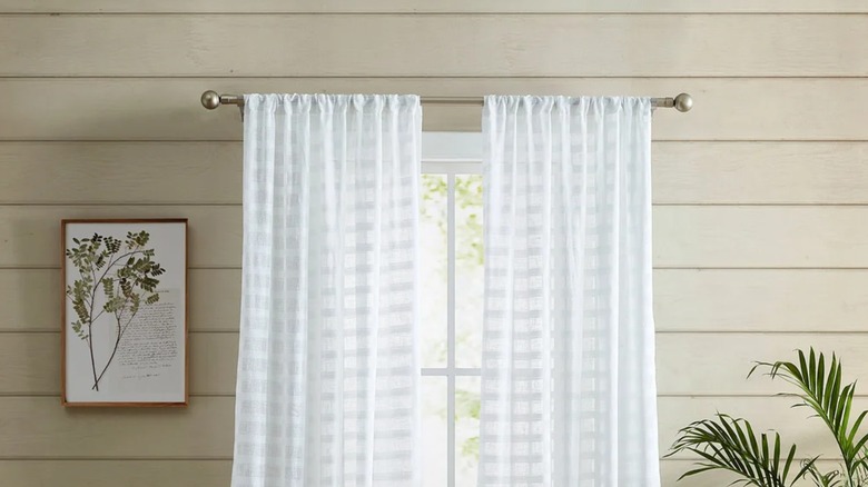 The lower half of the Hasting chenille curtains next to a light wood table