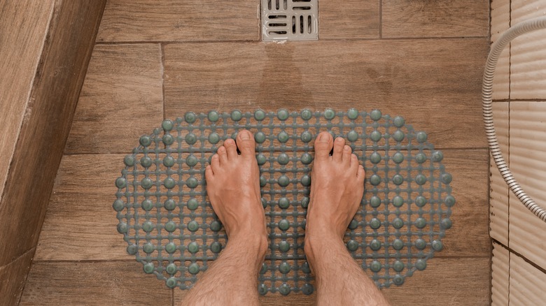 Person standing on a rubber anti-slip mat in the shower