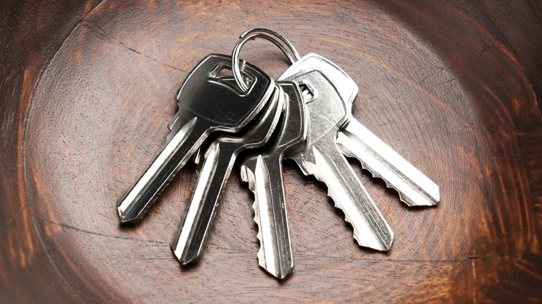 Close up of keys sitting in wooden bowl