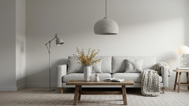 Gray living room set up with pendant light hanging from ceiling