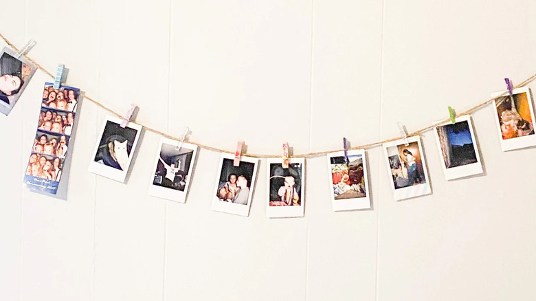 Photo wall hanging with clothes pegs and polaroid photos