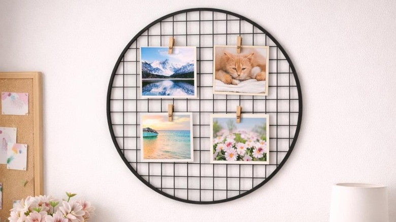 A round circular black wall grid with photos clipped to it.