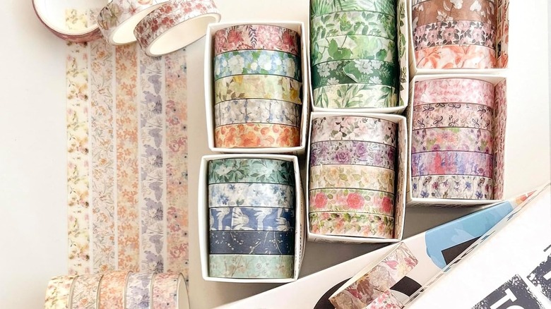 Different rolls of patterned washi tape with a floral theme.