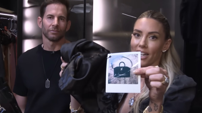 A woman puts fashionable, beautiful bags into fabric bags for neat storage.