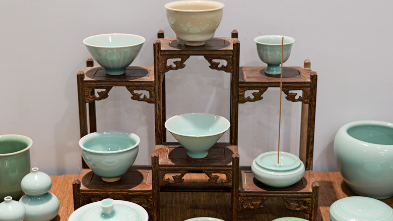 A display of celadon tea cups and dishes