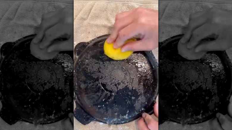 Man uses lemon and salt to scrub rust off of iron skillet