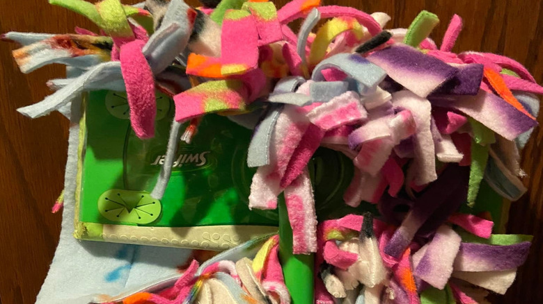 Various scraps of fleece used on a Swiffer as a mop pad