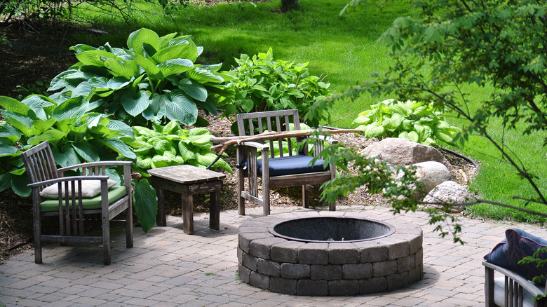 A backyard with a brick fire pit