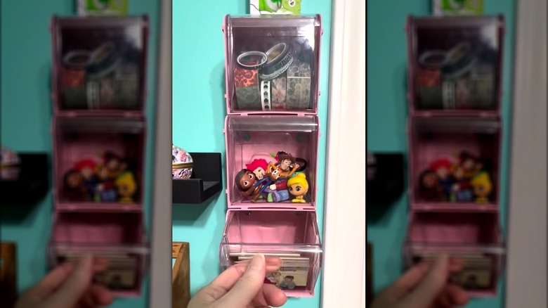 Stacking tilt bins with kids small toys on wall